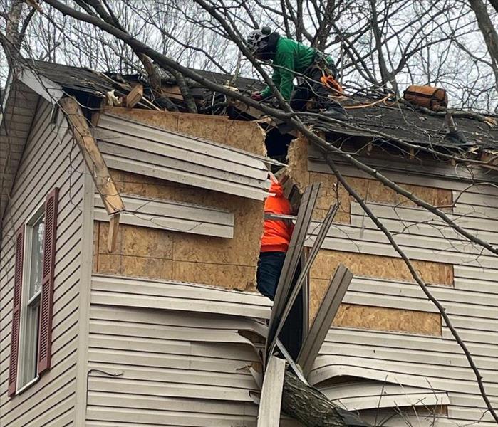 crew working on damaged roof