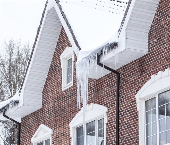 house with ice dripping off